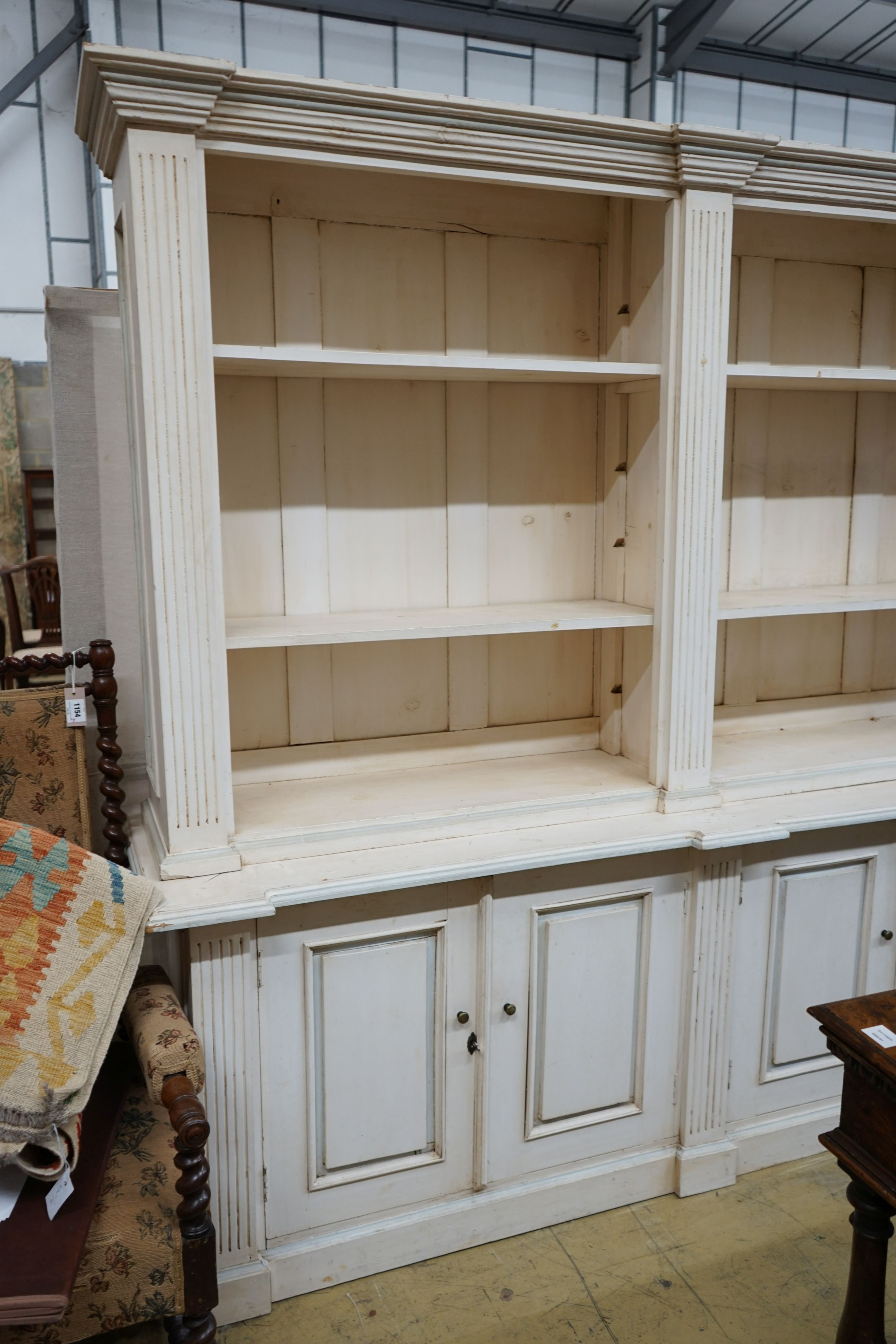 A modern George III style painted library bookcase, width 220cm depth 53cm height 208cm